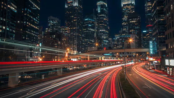 City at Night with Light Streaks from Cars on the Road