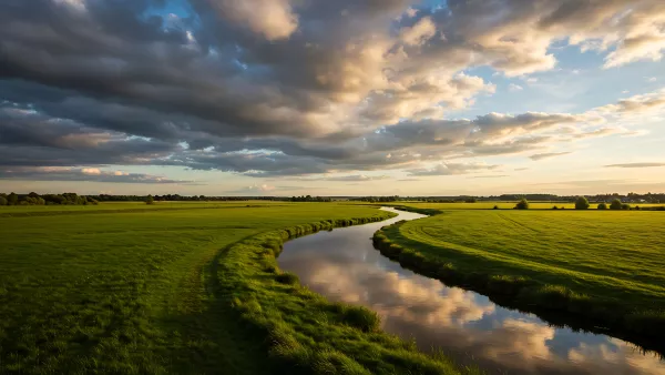 Golden Hour Glow Over Serene River and Lush Green Fields