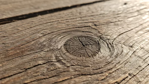 Close up of weathered wood grain with a knot