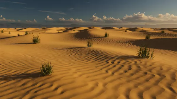 Golden Sand Dunes with Sparse Greenery Under Blue Sky