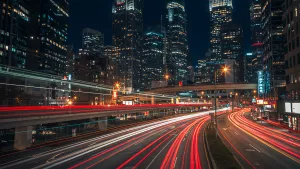 City at Night with Light Streaks from Cars on the Road